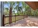 A lovely view of the water from the wood deck, framed by lush greenery and a striking palm tree at 613 Lake Ave, Altamonte Springs, FL 32701