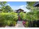 Inviting home exterior featuring lush landscaping, unique architectural design, and a welcoming entrance at 613 Lake Ave, Altamonte Springs, FL 32701