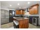 Well-appointed kitchen with an island, stainless steel fridge, and a wine cooler for entertaining at 613 Lake Ave, Altamonte Springs, FL 32701