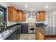 Gourmet kitchen with custom cabinetry, stainless steel appliances, and granite countertops at 613 Lake Ave, Altamonte Springs, FL 32701