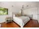 This bedroom features hardwood floors, a ceiling fan, a nightstand, and a dresser set at 613 Lake Ave, Altamonte Springs, FL 32701