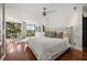 Bright main bedroom boasts a ceiling fan, a padded headboard, and windows with an outdoor view at 613 Lake Ave, Altamonte Springs, FL 32701