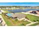 Aerial view of a home with a pool next to a serene pond at 62 Polermo Ave, St Cloud, FL 34771