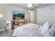 Neutral bedroom with a queen bed, television, and closet at 62 Polermo Ave, St Cloud, FL 34771