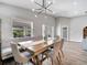 Bright and airy dining area with a modern light fixture and view to the backyard at 62 Polermo Ave, St Cloud, FL 34771