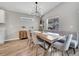Dining room with a large wooden table, modern chandelier, and comfortable seating for gatherings at 62 Polermo Ave, St Cloud, FL 34771