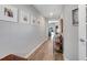 Hallway with wood floors, light gray walls, and decorative pictures at 62 Polermo Ave, St Cloud, FL 34771