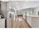 Modern kitchen with white cabinets, quartz countertops, stainless steel appliances, and a view into the dining room at 62 Polermo Ave, St Cloud, FL 34771