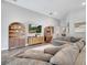 Comfortable living room with built-in bookshelves and a gray sectional couch for relaxing at 62 Polermo Ave, St Cloud, FL 34771