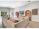 Open living room with a large tan sectional couch and sliding glass doors to the backyard at 62 Polermo Ave, St Cloud, FL 34771