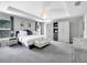 Main bedroom featuring tray ceilings, carpeted floors, and an attached ensuite bathroom at 62 Polermo Ave, St Cloud, FL 34771