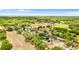 Aerial view showcases a peaceful neighborhood with tree-lined streets and well-kept homes, near community green spaces at 7025 Hiawassee Oak Dr, Orlando, FL 32818
