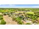 Aerial view showcases a peaceful neighborhood with tree-lined streets and well-kept homes, near community green spaces at 7025 Hiawassee Oak Dr, Orlando, FL 32818
