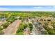 Scenic aerial view showcases a neighborhood, green trees, and nearby open fields at 7025 Hiawassee Oak Dr, Orlando, FL 32818