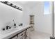 Modern bathroom with a double vanity, a decorative cabinet, and a window at 7025 Hiawassee Oak Dr, Orlando, FL 32818