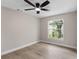 Bright bedroom with a ceiling fan, window, and neutral paint at 7025 Hiawassee Oak Dr, Orlando, FL 32818
