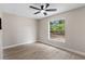 Bedroom with a ceiling fan, window, and neutral paint at 7025 Hiawassee Oak Dr, Orlando, FL 32818