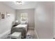 Cozy bedroom with a small window, overhead light, and rug at 7025 Hiawassee Oak Dr, Orlando, FL 32818