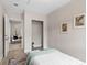 Bright bedroom with light wood floors, closet, and views into a living area at 7025 Hiawassee Oak Dr, Orlando, FL 32818
