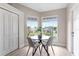Charming breakfast nook with hardwood floors, lots of natural light, and a modern table with seating for four at 7025 Hiawassee Oak Dr, Orlando, FL 32818