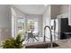 Bright breakfast nook off the kitchen features a stainless refrigerator, a round table and natural light at 7025 Hiawassee Oak Dr, Orlando, FL 32818
