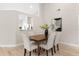 Formal dining room featuring a stylish table with upholstered chairs and a kitchen view at 7025 Hiawassee Oak Dr, Orlando, FL 32818