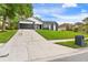 Lovely home with driveway and lush green lawn offers great curb appeal at 7025 Hiawassee Oak Dr, Orlando, FL 32818