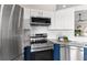 Close up view of a kitchen featuring stainless steel appliances, white subway tile, two-tone cabinets, and granite countertops at 7025 Hiawassee Oak Dr, Orlando, FL 32818