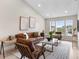 Living room area with hardwood floors, recessed lighting, a leather couch and two chairs at 7025 Hiawassee Oak Dr, Orlando, FL 32818
