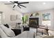 Cozy living room boasts a fireplace, hardwood floors, natural light, and contemporary furnishings at 7025 Hiawassee Oak Dr, Orlando, FL 32818