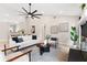 Bright and airy living room with modern decor, a ceiling fan, hardwood floors and an open floor plan at 7025 Hiawassee Oak Dr, Orlando, FL 32818