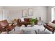 Spacious living room featuring hardwood floors, recessed lighting, a leather couch and two chairs at 7025 Hiawassee Oak Dr, Orlando, FL 32818
