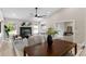Open concept living room featuring a black fireplace, neutral paint, and large windows for natural light at 7025 Hiawassee Oak Dr, Orlando, FL 32818
