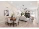 Open concept living and dining area with hardwood floors, a fireplace, and lots of natural light at 7025 Hiawassee Oak Dr, Orlando, FL 32818