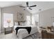 Bright main bedroom with a ceiling fan, an ensuite bathroom, large window, and a closet at 7025 Hiawassee Oak Dr, Orlando, FL 32818