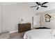 Spacious main bedroom with a fan, dresser, and neutral colors at 7025 Hiawassee Oak Dr, Orlando, FL 32818