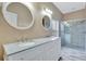 Bathroom featuring double sink vanity and a glass-enclosed shower at 709 Strihal Loop, Oakland, FL 34787