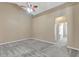 Neutral bedroom with vaulted ceiling, fan, and doorway to other rooms at 709 Strihal Loop, Oakland, FL 34787