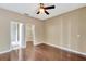 Bedroom showcasing hardwood floors and open doorway to the bathroom at 709 Strihal Loop, Oakland, FL 34787