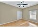 A spacious bedroom with a ceiling fan, closet and a window at 709 Strihal Loop, Oakland, FL 34787