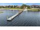 Waterfront dock offering access to the lake, great for boating, fishing, and enjoying water activities at 709 Strihal Loop, Oakland, FL 34787