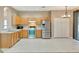 Bright kitchen features stainless steel appliances and light wood cabinetry at 709 Strihal Loop, Oakland, FL 34787