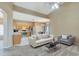 Open-concept living room flows into a modern kitchen with stainless steel appliances, perfect for entertaining at 709 Strihal Loop, Oakland, FL 34787