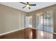 Living room boasts hardwood flooring, with views of the kitchen and patio at 709 Strihal Loop, Oakland, FL 34787
