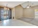 Inviting living area boasts tile and carpet flooring, with modern chandelier at 709 Strihal Loop, Oakland, FL 34787