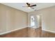 Empty main bedroom boasts a ceiling fan and doorway to closet and bathroom at 709 Strihal Loop, Oakland, FL 34787