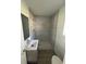 Bathroom featuring walk-in shower with tile surround, modern fixtures, and hardwood floors at 73 Brooks Dr, Ormond Beach, FL 32176