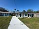 Front exterior showcasing the house, driveway, and landscaping on a sunny day at 73 Brooks Dr, Ormond Beach, FL 32176