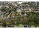 Aerial view of a neighborhood near a lake, featuring mature trees, docks, and waterfront properties at 7470 Lake Marsha Dr, Orlando, FL 32819