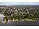 Wide aerial shot of lakefront homes along a heavily wooded shoreline, showcasing docks and the surrounding community at 7470 Lake Marsha Dr, Orlando, FL 32819
